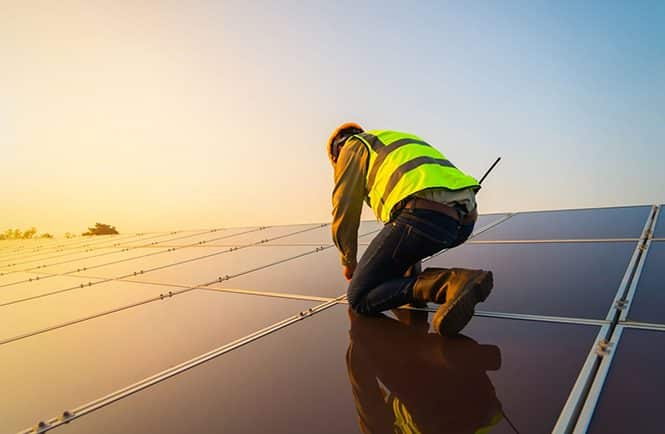 Ingeniero revisando instalación fotovoltaica coplanar sobre cubierta Nébula Energía